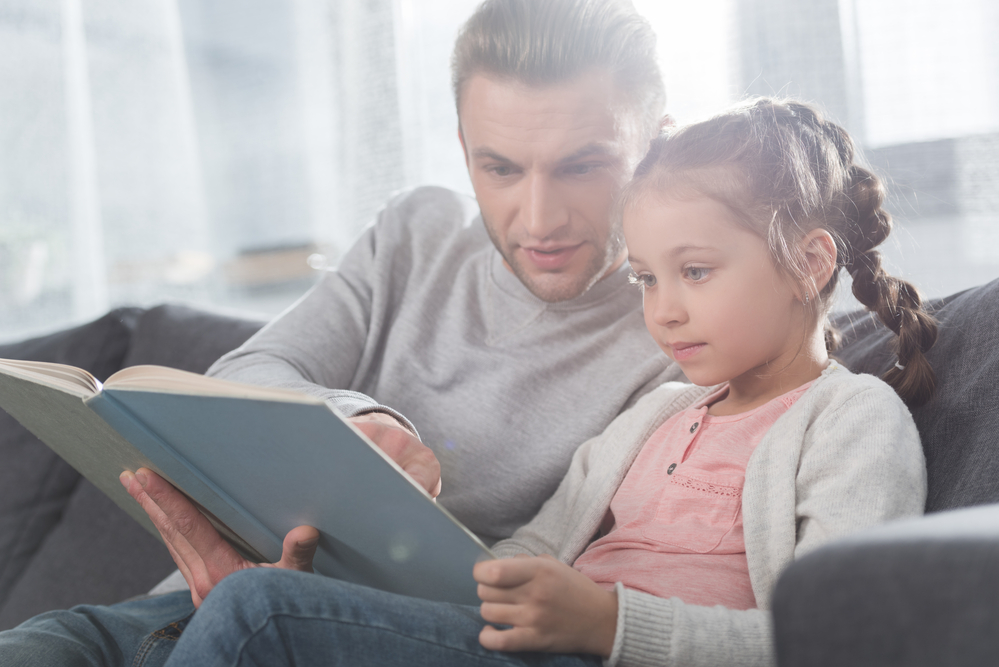Dad reading to daughter
