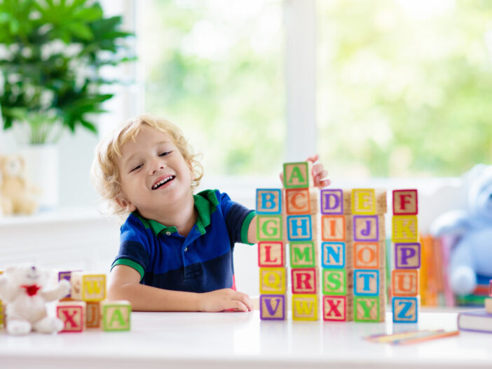 Kid learning letters with blocks