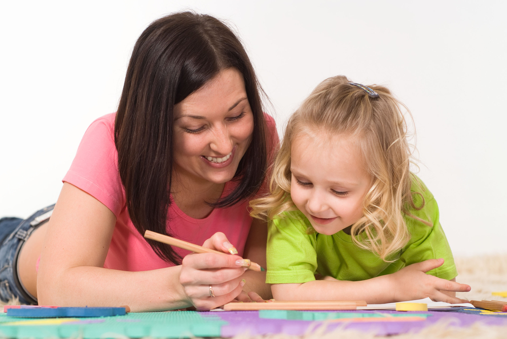 Mom helping daughter with writing games