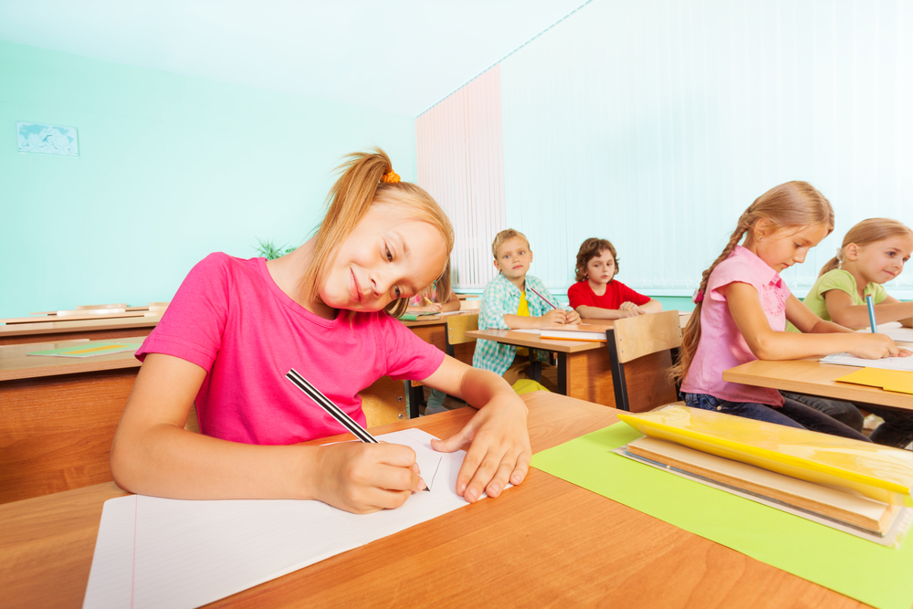 Young girl in class playing writing games