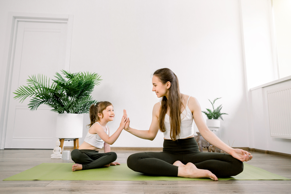 Mom giving high five to daughter after a meditation for kids session
