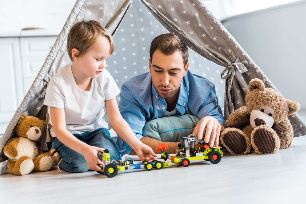 Dad using toys to teach ordinal numbers for kids to his son