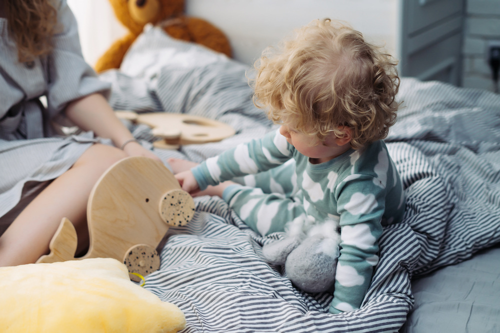 toddler playing with a toy before bedtime