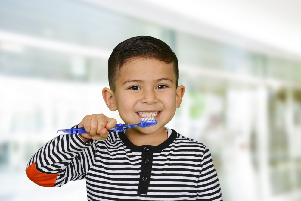 Young child who is brushing their teeth as part of a bedtime-routine
