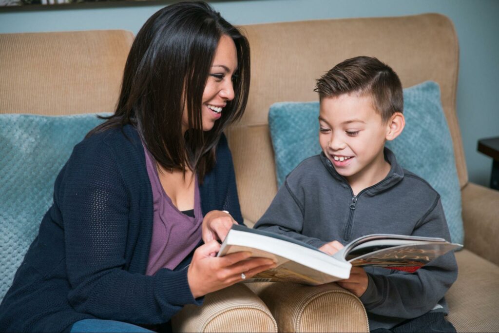 Mom reading to son for literacy development