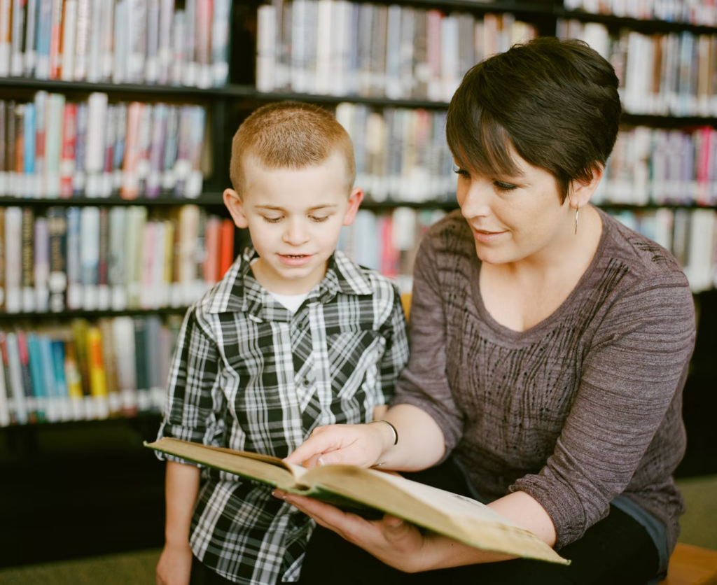 Mom at the library with son for literacy development