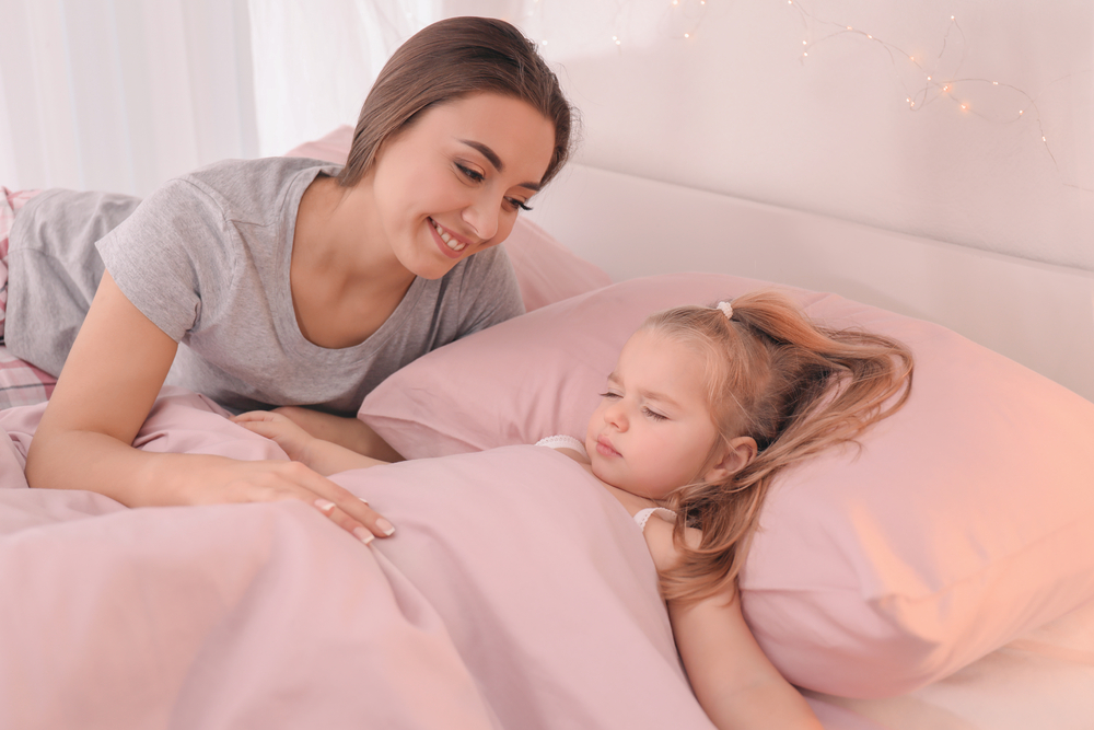 Mom getting daughter to bed early 
