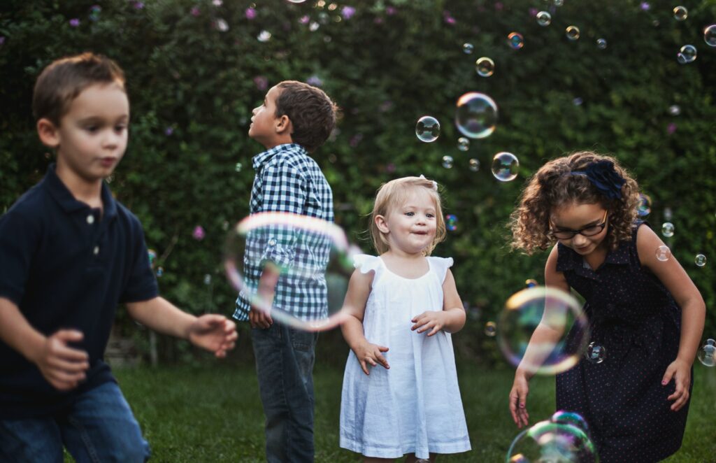 Young kids playing with bubbles