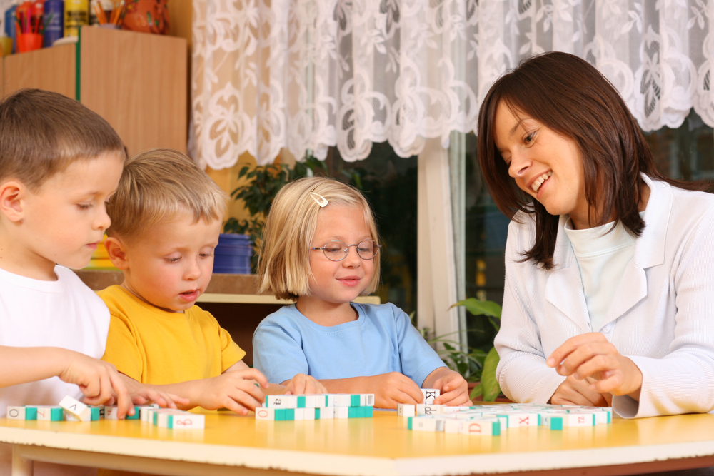 Teacher using letter blocks to teach High-Frequency Words to kids