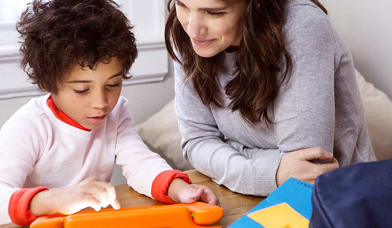 Young kid and mom using a tablet together to help with reading
