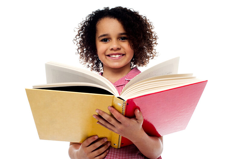 Adorable school girl reading a book with a smile