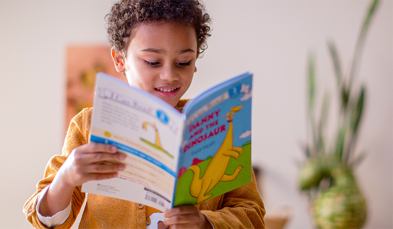 Young kid reading a book