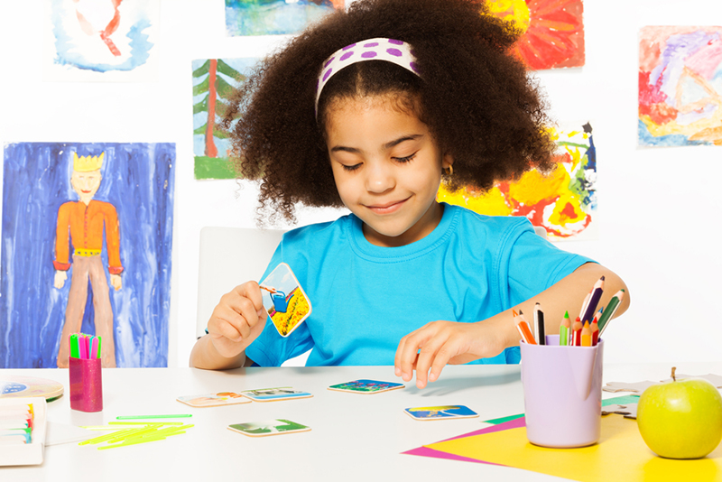 Young girl playing a matching card game