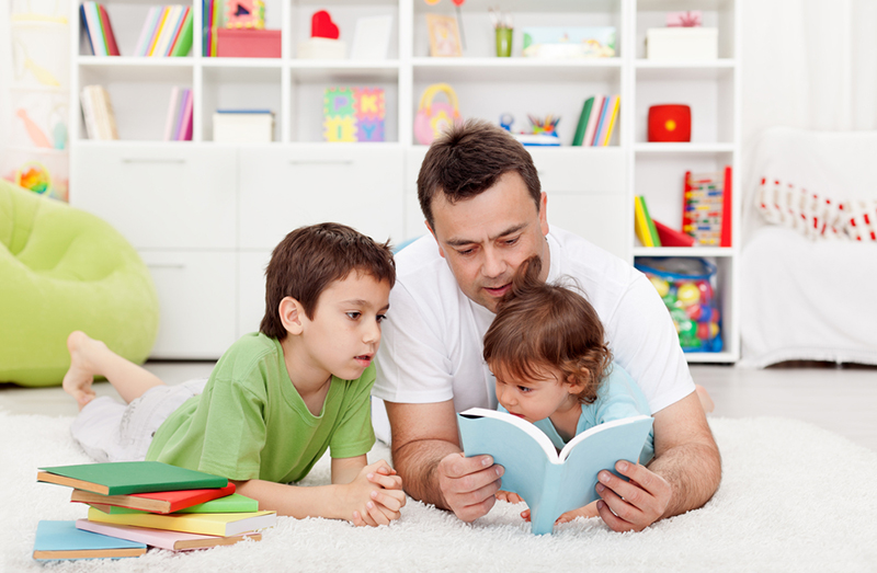 Family avoiding summer slide by reading together