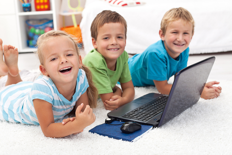 Three kids working on a laptop