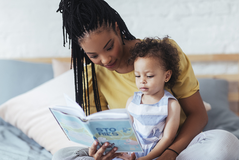 Mom reading to young daughter