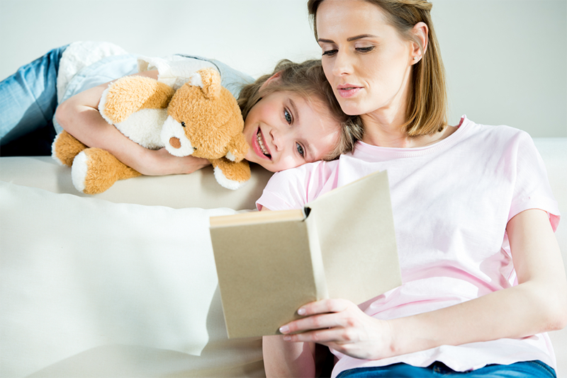 Mom reading to young daughter