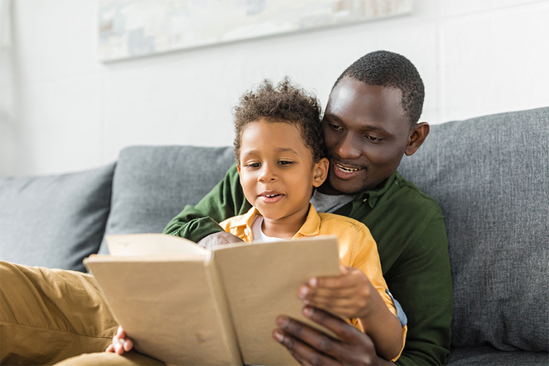 Dad teaching young son about alphabetic principle