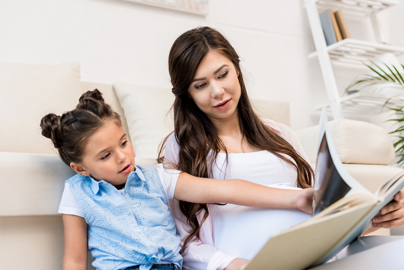 Mom teaching daughter alphabetic principle