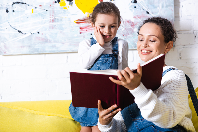 Mom reading to young daughter 