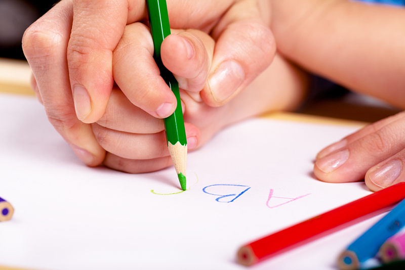 Parent helping with uppercase letters and lowercase letters