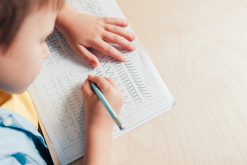 Kid practicing drawing different types of lines