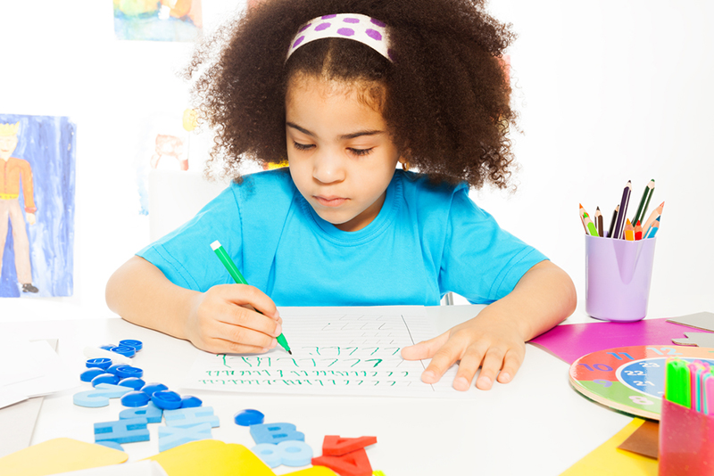 Girl practicing letter formation 