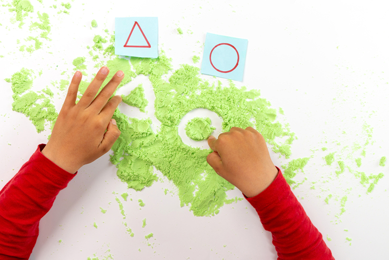 Kid playing with colored flour 