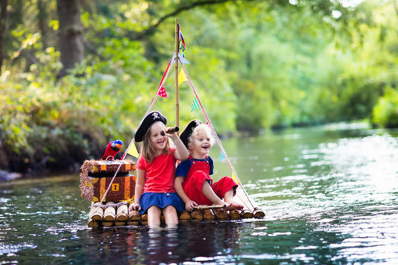 Siblings on a raft pretending to be pirates