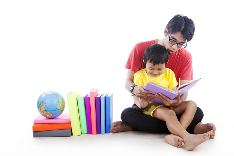 Dad reading math books with child