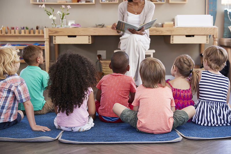 Teacher reading to preschoolers